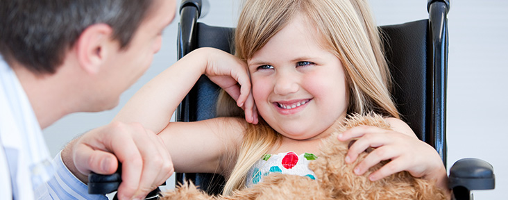 Smiling Girl Sitting in a Wheelchair
